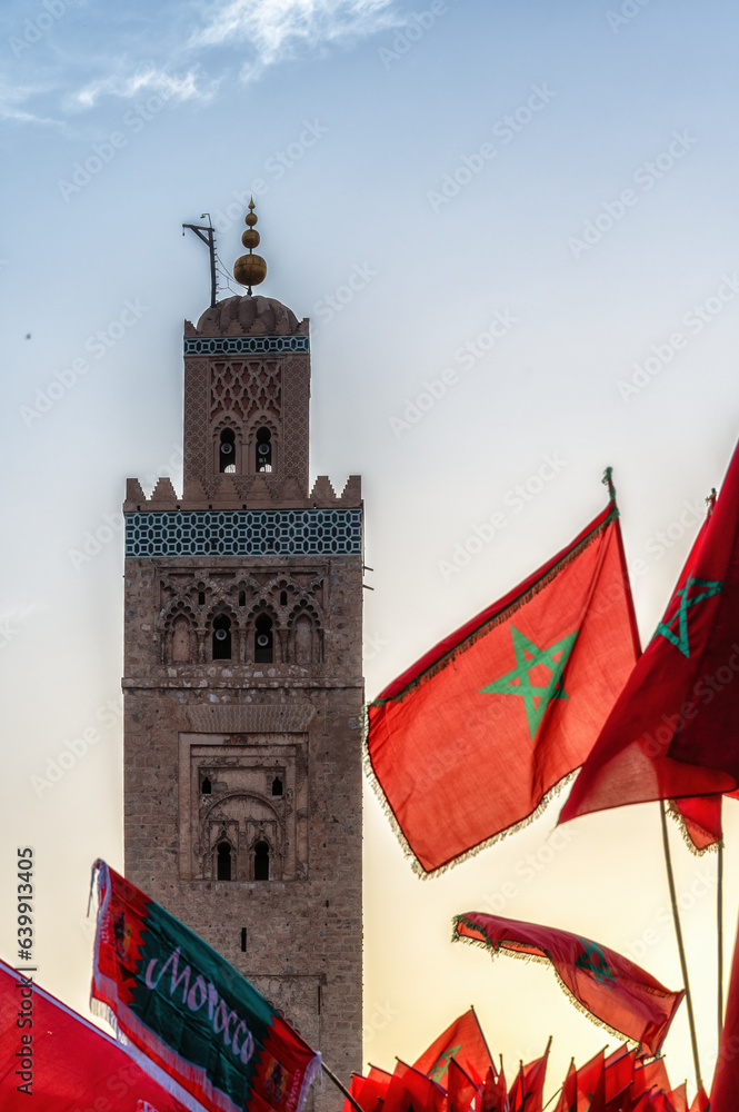Moroccan flags and landmark minaret tower