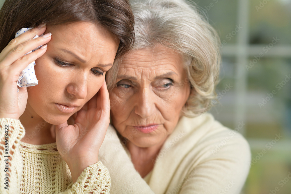 Portrait of sad Senior woman with daughter at home Portrait of sad Senior woman with daughter at home