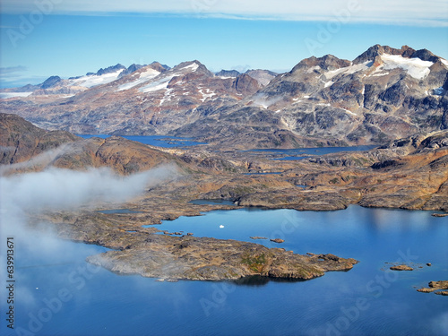 aerial view mountains and fog in arctic ocean, greenland