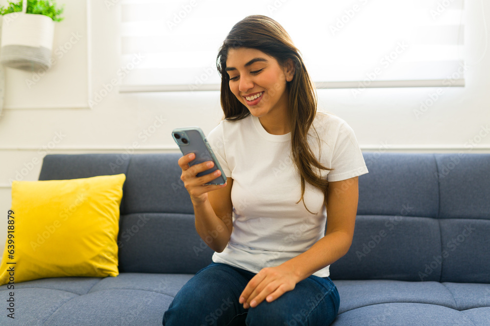 Happy young woman with a mockup t-shirt texting Happy young woman with a mockup t-shirt texting