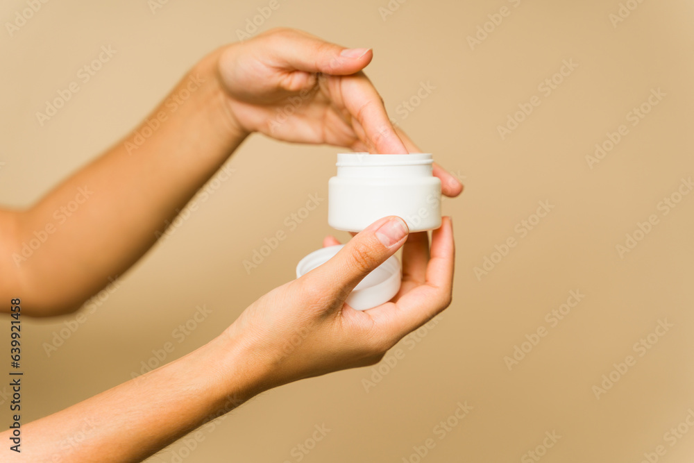 Young adult hands using moisturizer lotion and mockup skinc are products Young adult hands using moisturizer lotion and mockup skinc are products