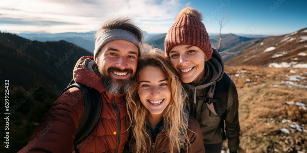 Family hikers taking self portrait on the top of mountain