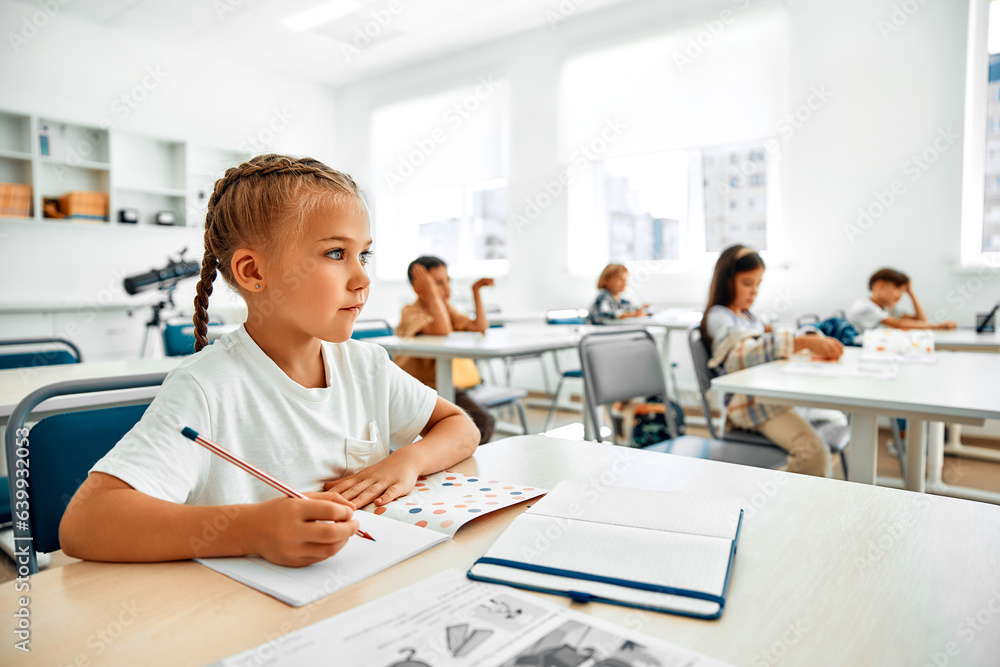 Fototapeta premium Children learning in a school classroom