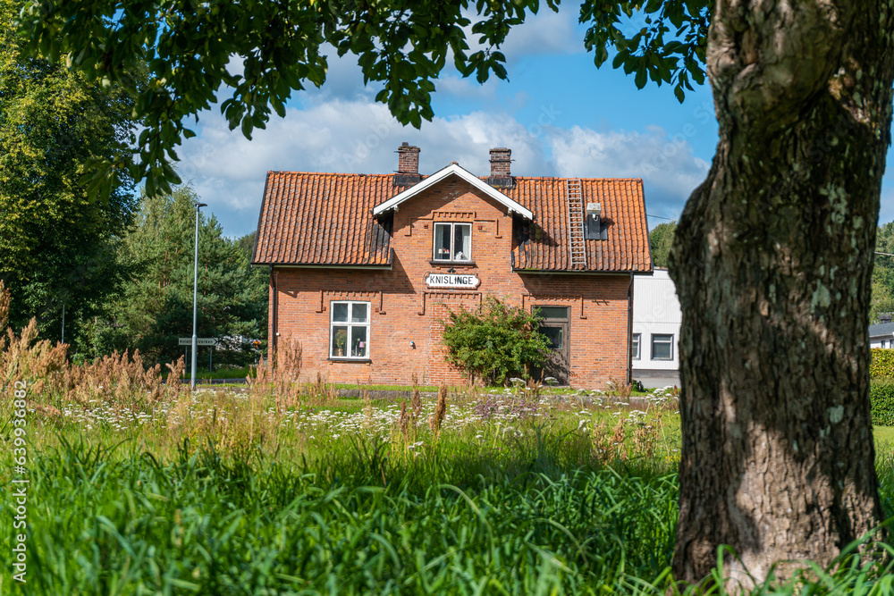 An old vintage private house from red bricks in front of abandoned railway station in Knislinge, Sweden