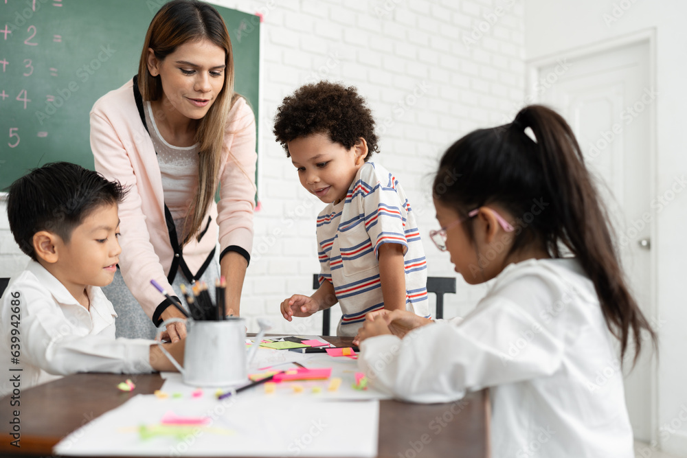 Teacher woman teaching children with paper and blackboard in class room Teacher woman teaching children with paper and blackboard in class room