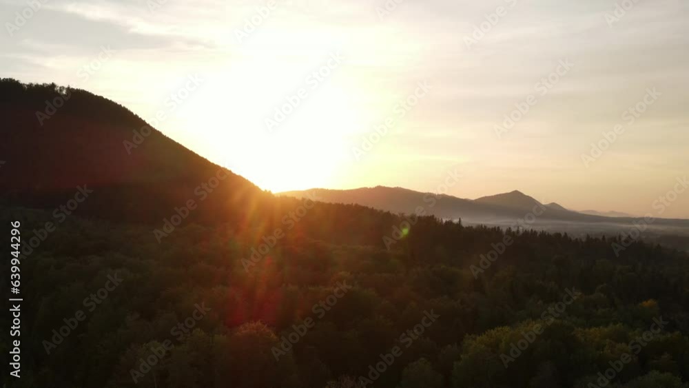 Beautiful idyllic aerial view of amazing mountains and green forest during warm sunset or sunrise. Flying with drone over majestic woodland and mountain in warm summer sunny day. Nature concept Beautiful idyllic aerial view of amazing mountains and green forest during warm sunset or sunrise. Flying with drone over majestic woodland and mountain in warm summer sunny day. Nature concept