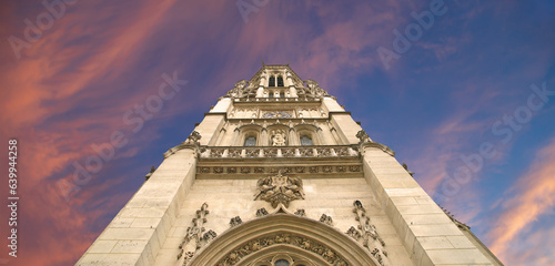 Great gothic church of Saint Germain l Auxerrois (against the background of a sky at sunset), Paris, France photo