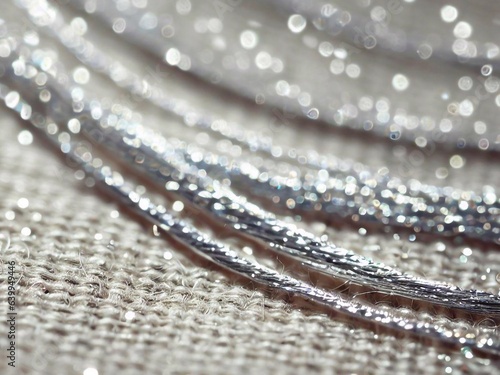 Glittering silver threads on textured cotton canvas