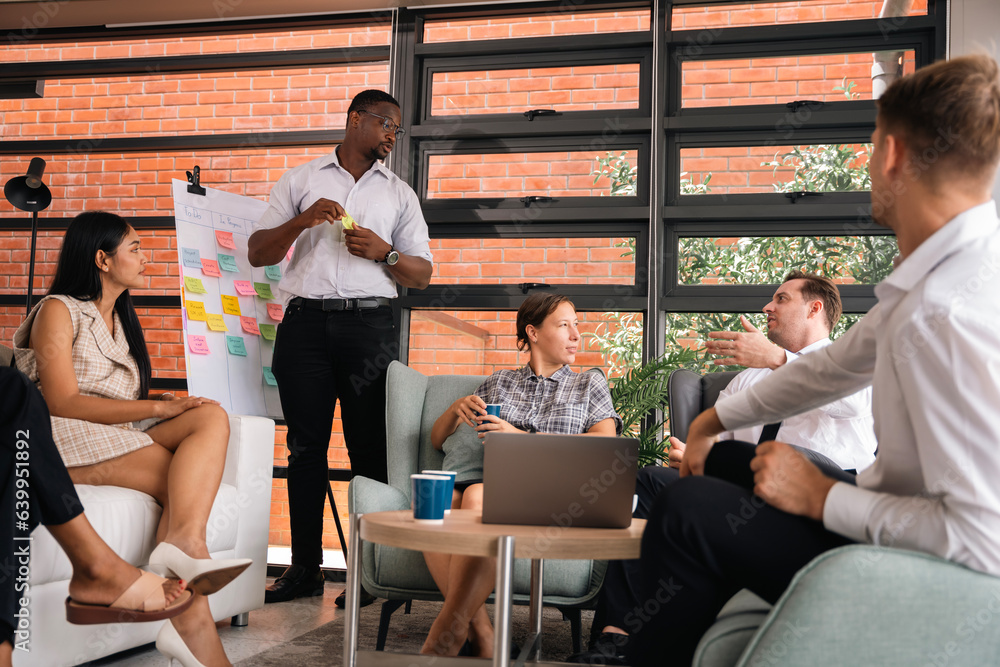 Male mature caucasian ceo businessman leader with diverse coworkers team executive managers group meeting. Multicultural professional businesspeople working together on research plan boardroom. Male mature caucasian ceo businessman leader with diverse coworkers team executive managers group meeting. Multicultural professional businesspeople working together on research plan boardroom.