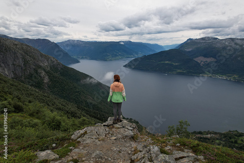defaultWoman standing in silence over the norwegian fjords