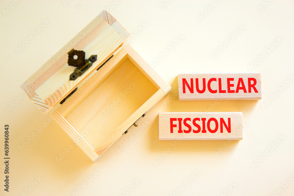 Nuclear fission symbol. Concept words Nuclear fission on beautiful wooden blocks. Beautiful white table white background. Empty wooden chest. Business science nuclear fission concept. Copy space. Nuclear fission symbol. Concept words Nuclear fission on beautiful wooden blocks. Beautiful white table white background. Empty wooden chest. Business science nuclear fission concept. Copy space.