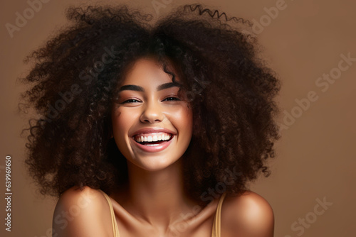 photograph of Beautiful african american girl with an afro hairstyle smiling © JKLoma