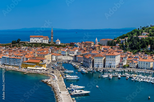 A close up aerial view across the harbour and old town of Piran, Slovenia in summertime