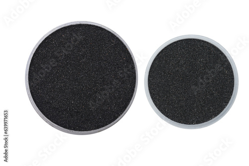 Specimens of milled Ilmenite mineral sand on small trays on isolated white background photo