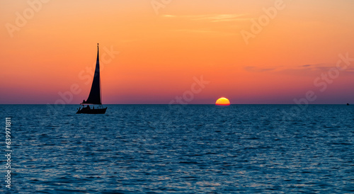 small sailboats floating on the sea in a beautiful sunset in high resolution and high sharpness