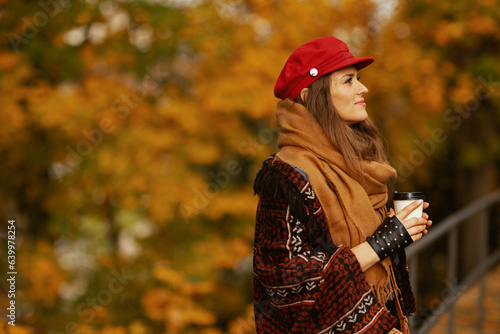 pensive woman in red hat with scarf