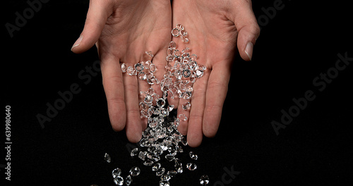 Hand of Woman with Diamonds against Black Background