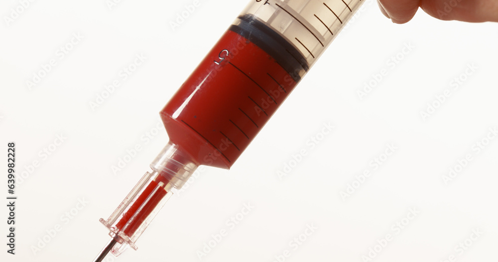 Blood dropping from Needle against White Background Blood dropping from Needle against White Background