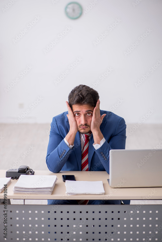 Young male employee working in the office Young male employee working in the office
