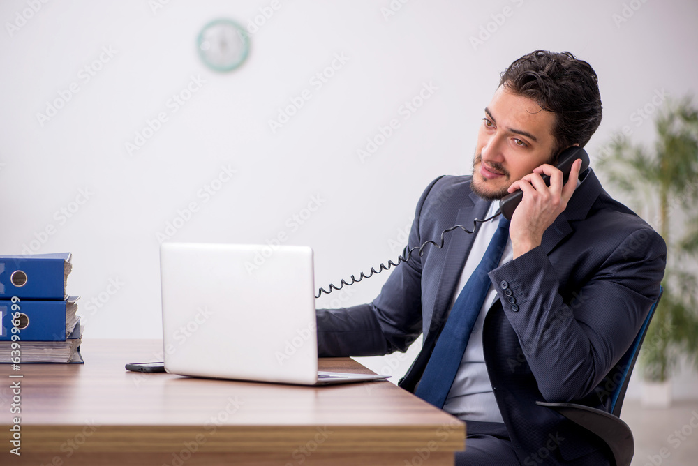 Young male employee working in the office Young male employee working in the office