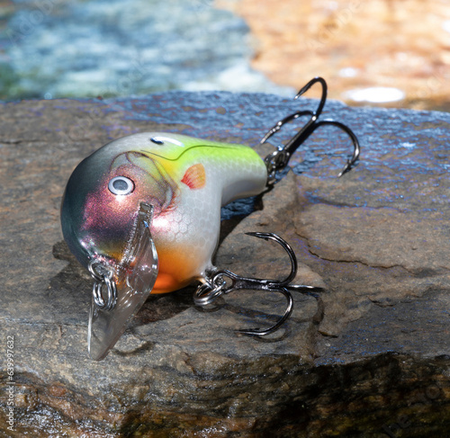 Coloirful water behind a fishing lure photo