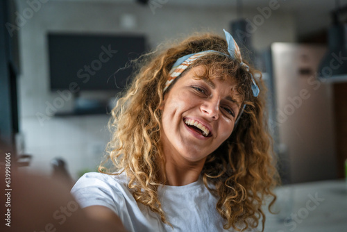 Close up portrait of one adult woman with curly hair happy smile