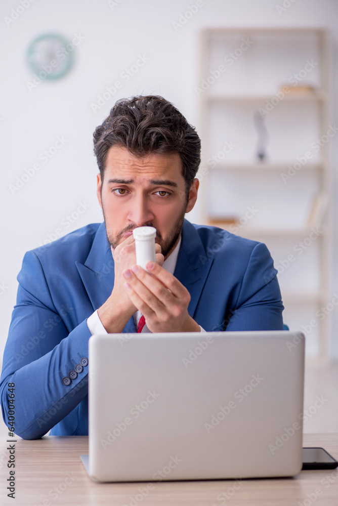 Young male employee feeling bad at workplace Young male employee feeling bad at workplace