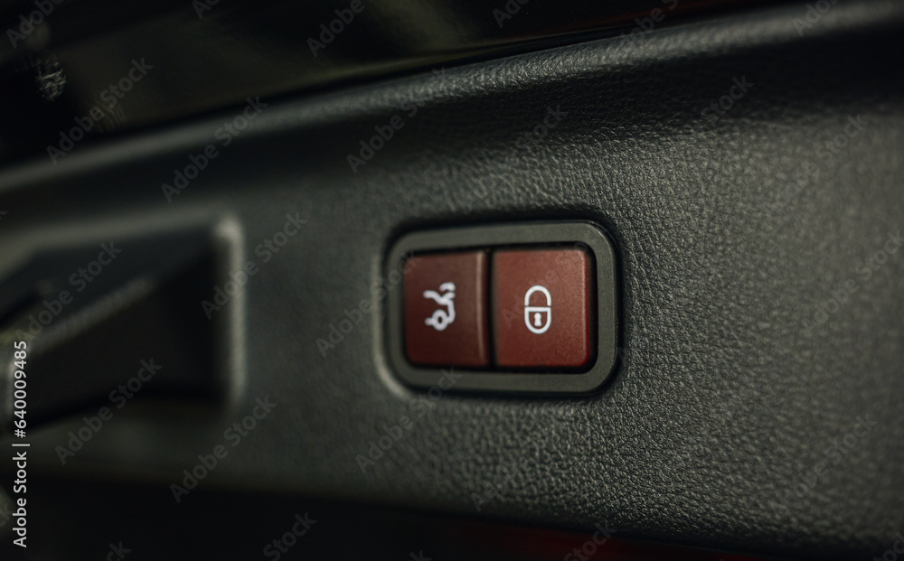 Close-up of the trunk release button. modern car interior. Automatically opening and closing the trunk of a car as luxurious extra equipment. Close-up of the trunk release button. modern car interior. Automatically opening and closing the trunk of a car as luxurious extra equipment.