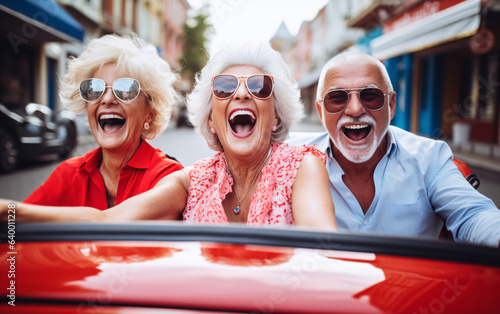 Company of elderly friends of pensioners ride in a convertible on a joint trip