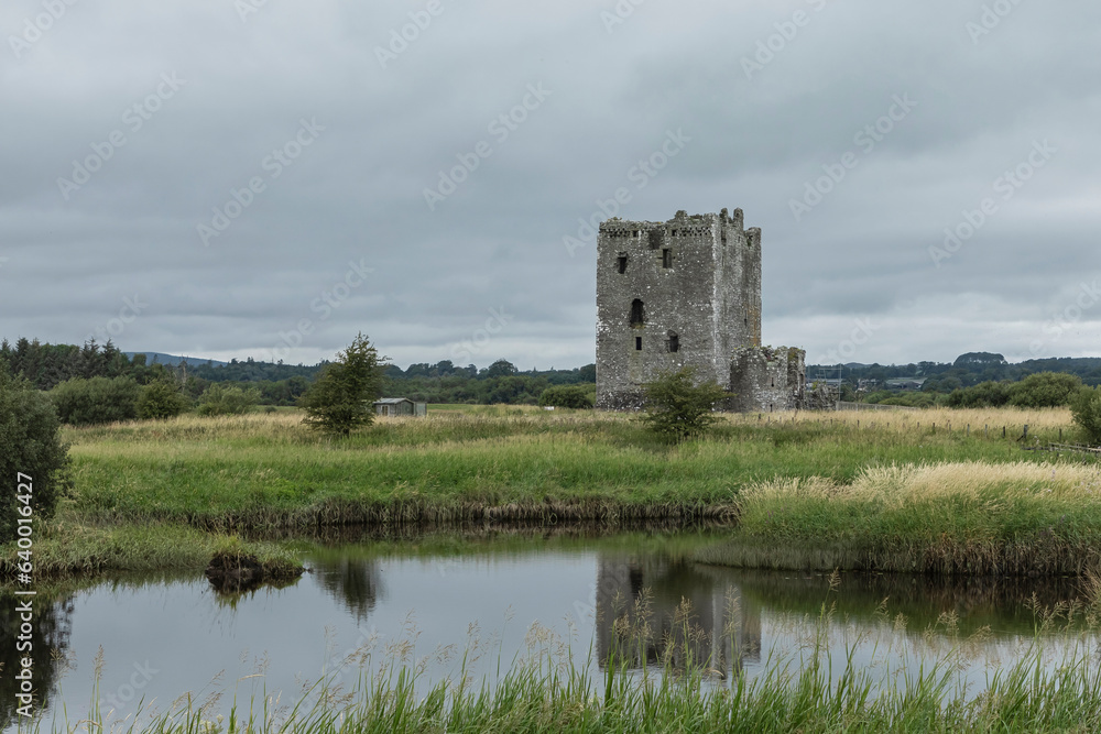 Derelict castle on a island reflected in the water