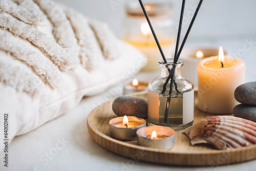 Cozy corner for home meditation and relaxation. Aroma diffuser, burning candles, stones for comfort, pleasure, aromatherapy. Decor for apartment, house, indoors design