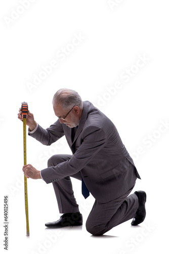Old businessman holding tape measure isolated on white © Elnur
