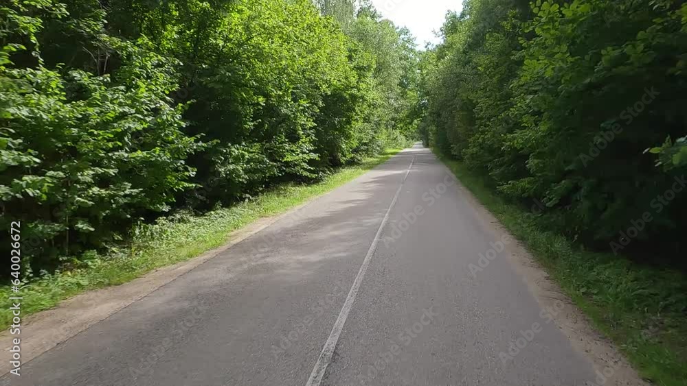 The car drives along the road on a summer day. Highways, roadside and road line markings. The car drives along the road on a summer day. Highways, roadside and road line markings.