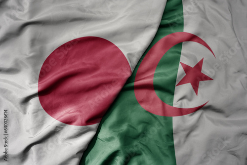 Photography big waving national colorful flag of japan and national flag of algeria