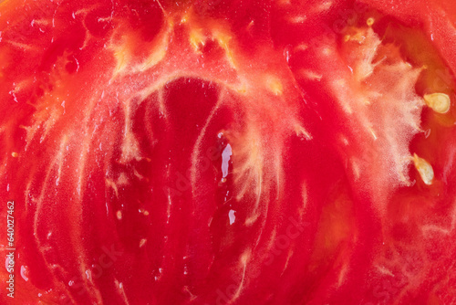macro detail of inside fresh tomato ,  sliced tomato close up © Vera Kuttelvaserova