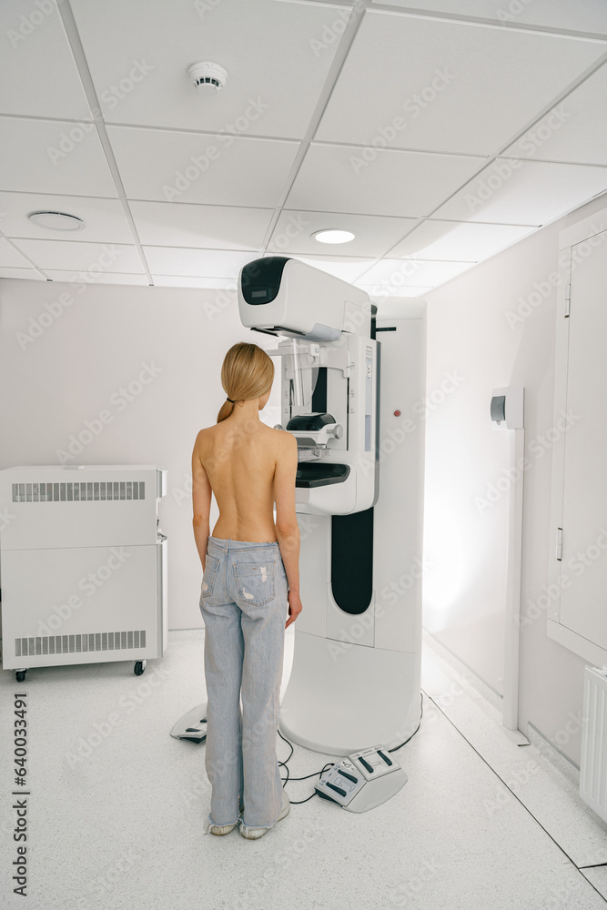 Woman doing mammogram x ray for breast cancer prevention screening at hospital. High quality photo Woman doing mammogram x ray for breast cancer prevention screening at hospital. High quality photo