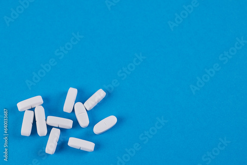 blue background with white pills in below left corner, space for text