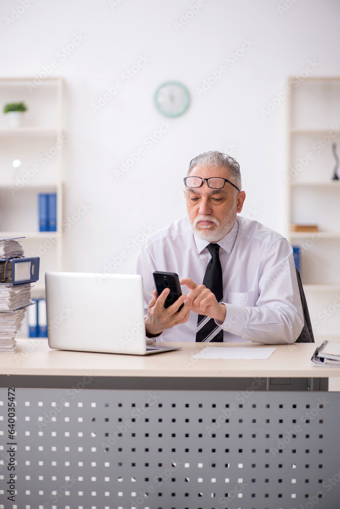 Old male employee and too much work in the office Old male employee and too much work in the office