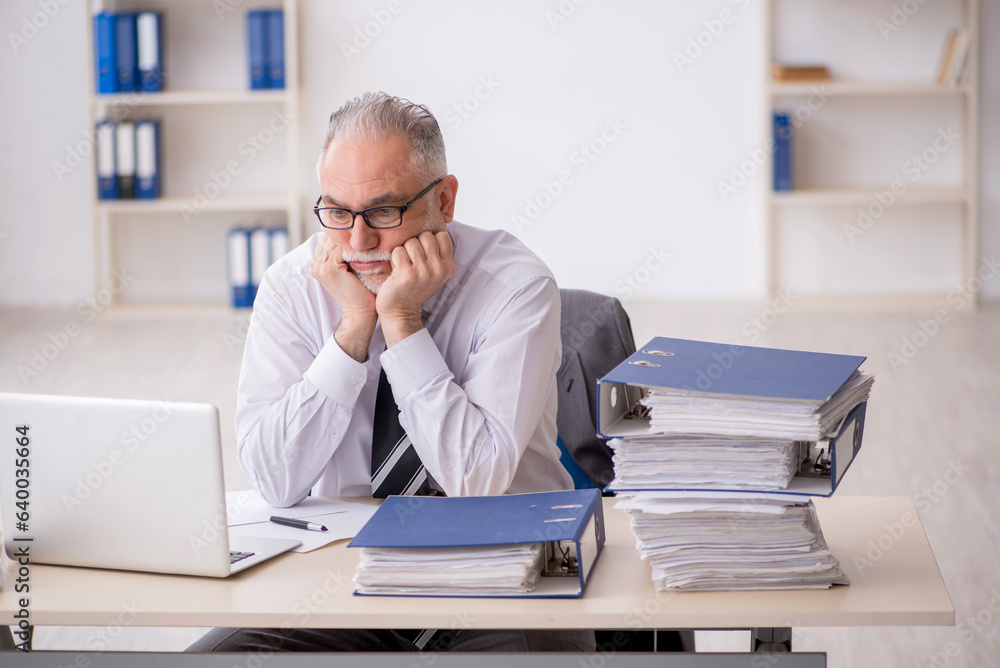 Old male employee and too much work in the office Old male employee and too much work in the office