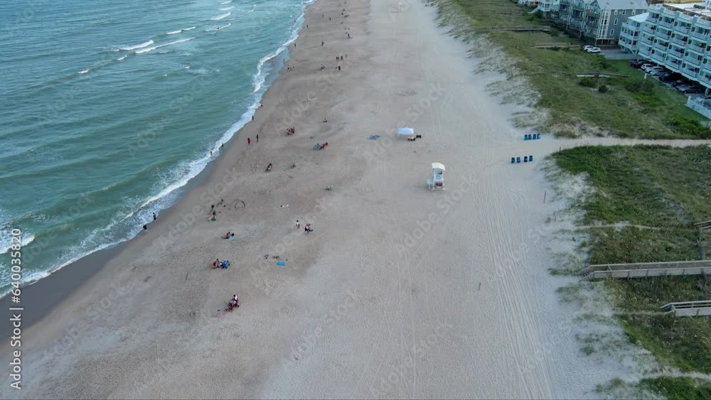 tilt aerial footage along the Atlantic coastline with blue ocean water ...