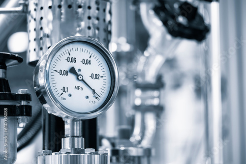 Industrial  concept. equipment of the boiler-house, - valves, tubes, pressure gauges, thermometer. Close up of manometer, pipe, flow meter, water pumps and valves of heating system in a boiler room. photo