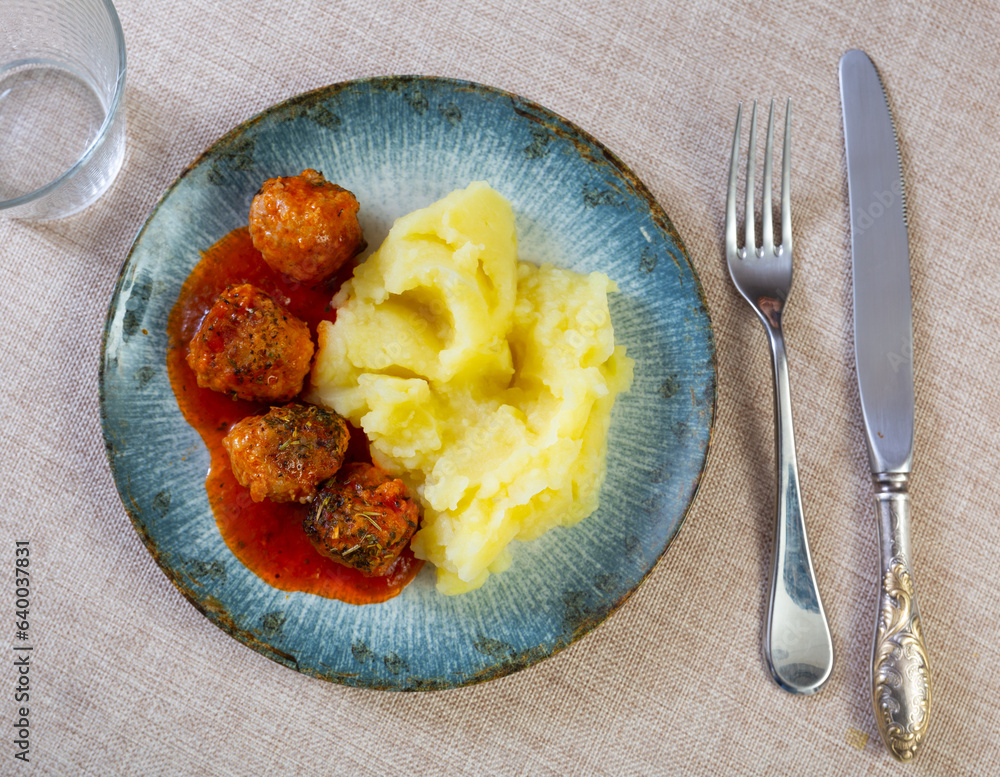 Nice tasty meatballs served with mashed potatoes and gravy on side