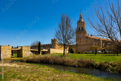 Burgo de Osma Cathedral, Soria, Spain. Landscape under blue sky in afternoon with view of bridge across Ucero river. photo