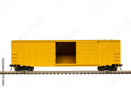 A yellow railroad box car with open door on train track.