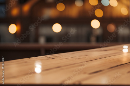 Empty wooden table in a cafe, illuminated by the soft twinkle of bokeh lights in the background