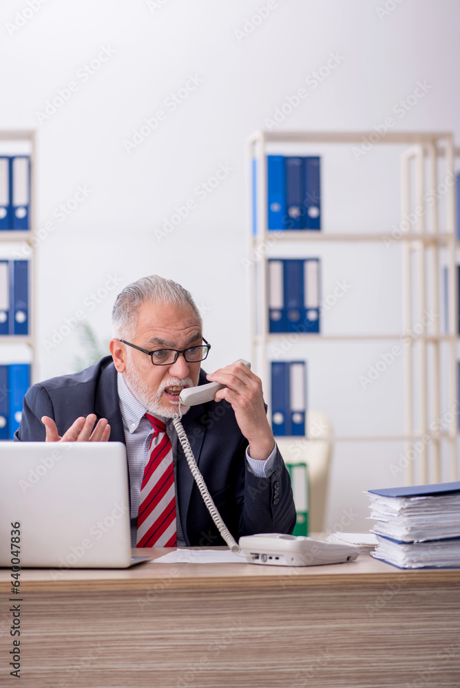 Old male employee and too much work in the office Old male employee and too much work in the office