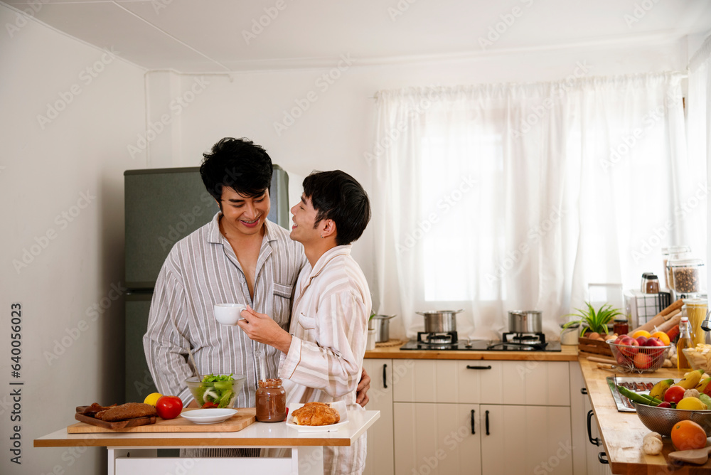 Happy gay couple enjoy breakfast in kitchen drinking coffee. Two best friends LGBTQ relation partner home cooking. Happiness romance homosexual marriage lifestyle. Two men together love friendship. Happy gay couple enjoy breakfast in kitchen drinking coffee. Two best friends LGBTQ relation partner home cooking. Happiness romance homosexual marriage lifestyle. Two men together love friendship.