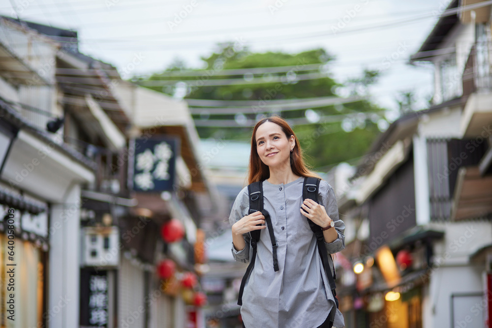 Fototapeta premium 商店街を歩くリュックを背負った外国人の旅行者