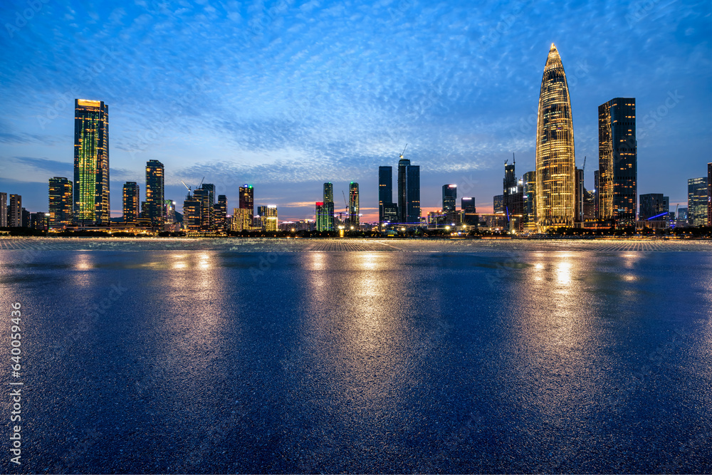 Asphalt road and urban skyline with modern buildings at night in Shenzhen, Guangdong Province, China.