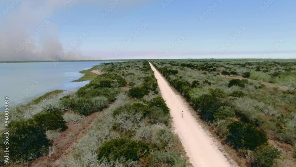 person running next to lake, wide aerial shot, solo runner, female jogging in nature. person running next to lake, wide aerial shot, solo runner, female jogging in nature.